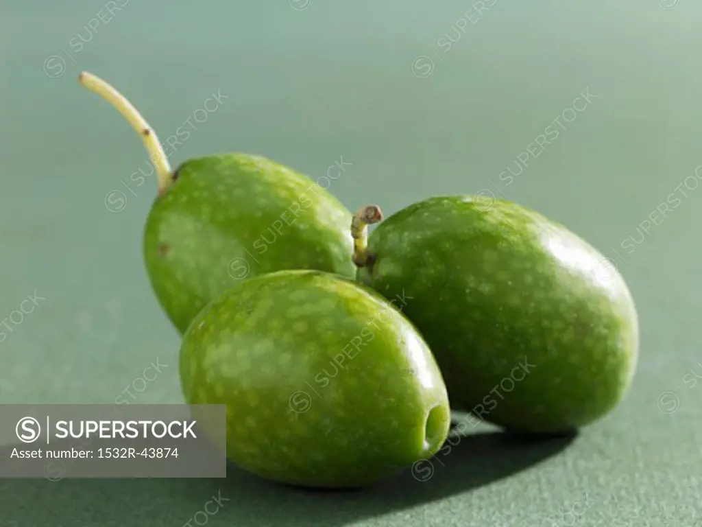 Three green olives (close-up)