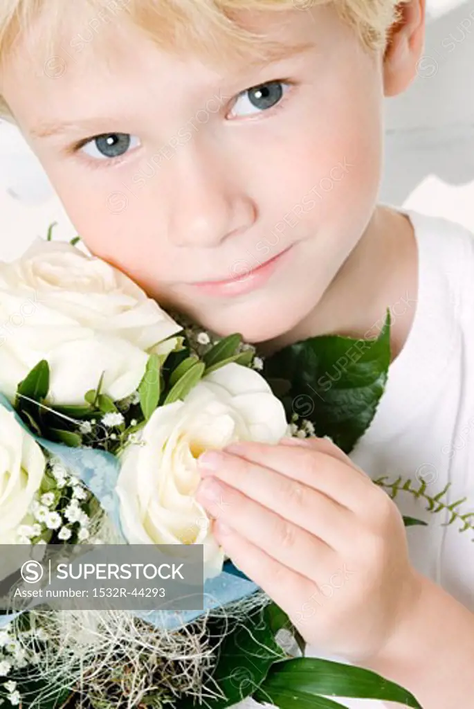 Boy with bouquet of white roses