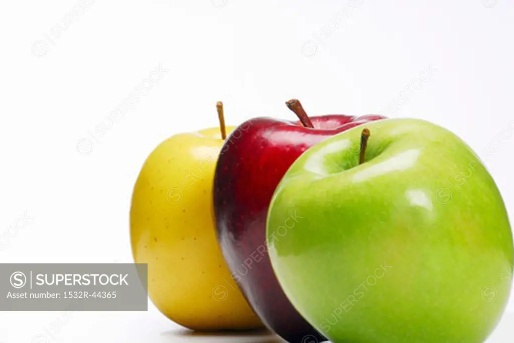 One green, one red and one yellow apple