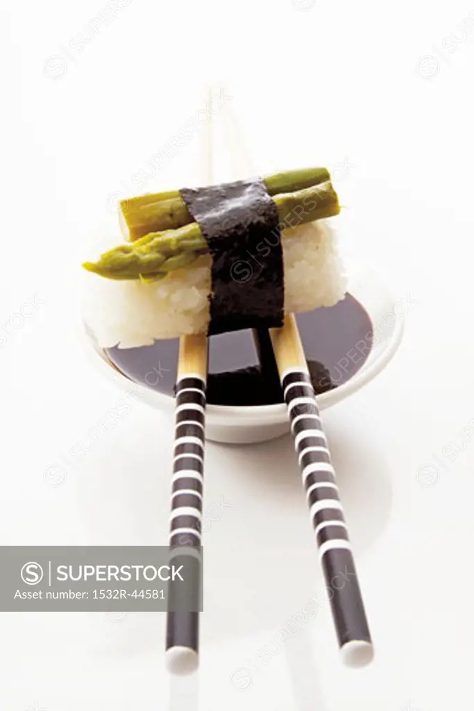 Asparagus nigiri sushi with soy sauce and chopsticks