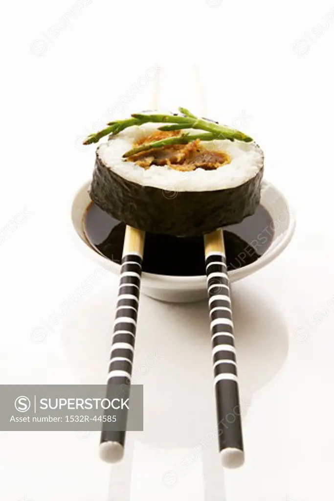 Maki sushi with soy sauce and chopsticks