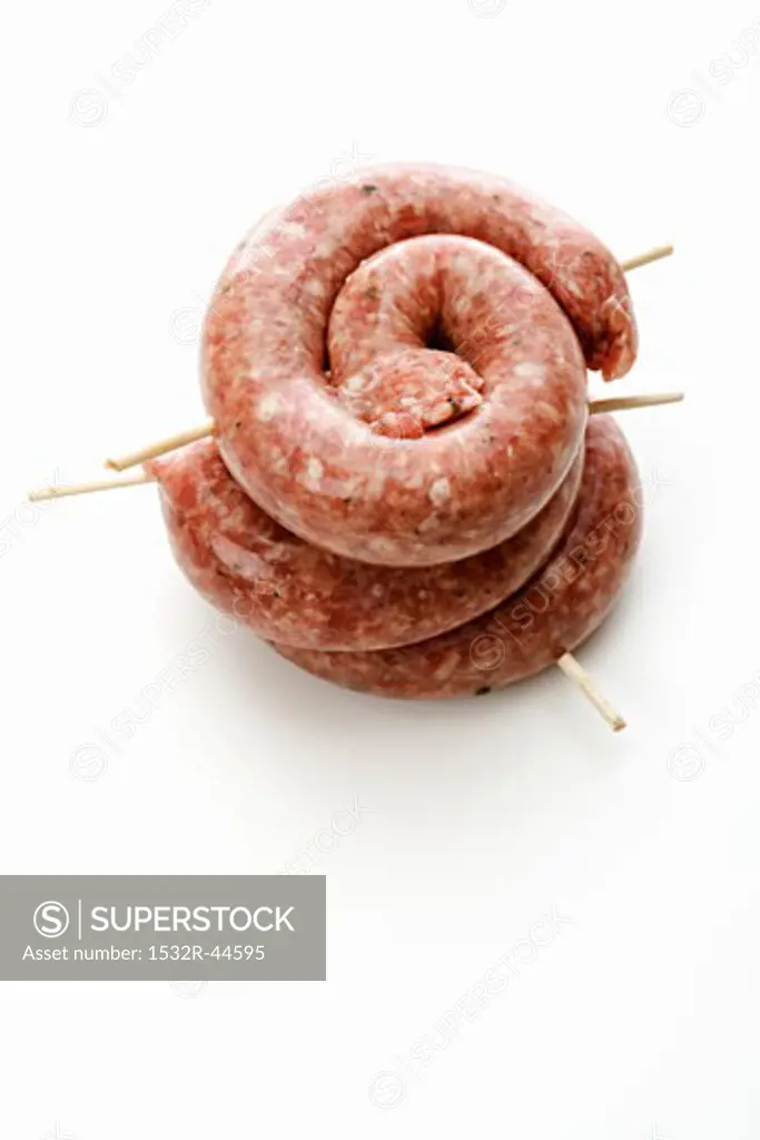 Three coiled sausages in a pile