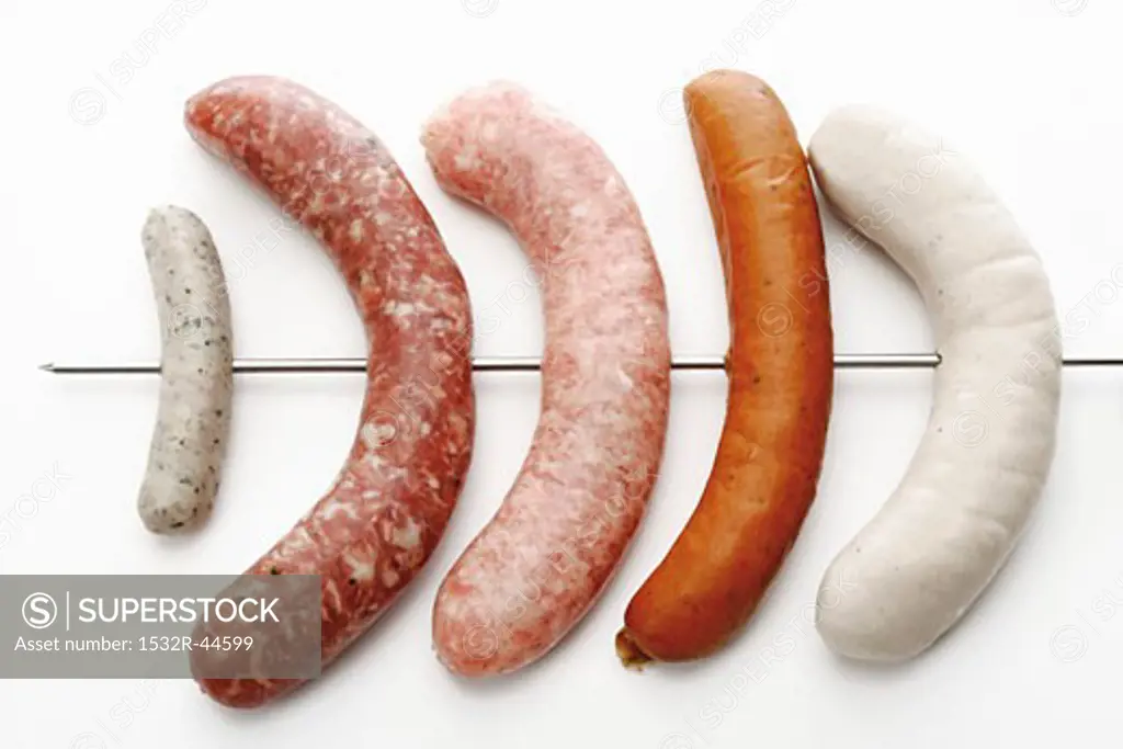 Various types of sausages, on a skewer