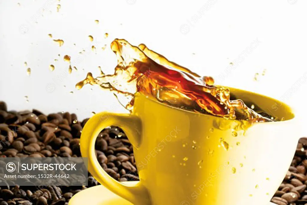 Coffee spilling out of a cup