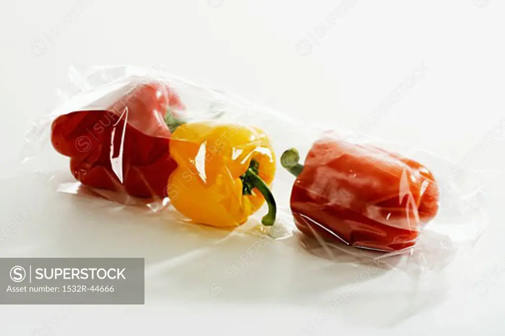 Three peppers in plastic packaging
