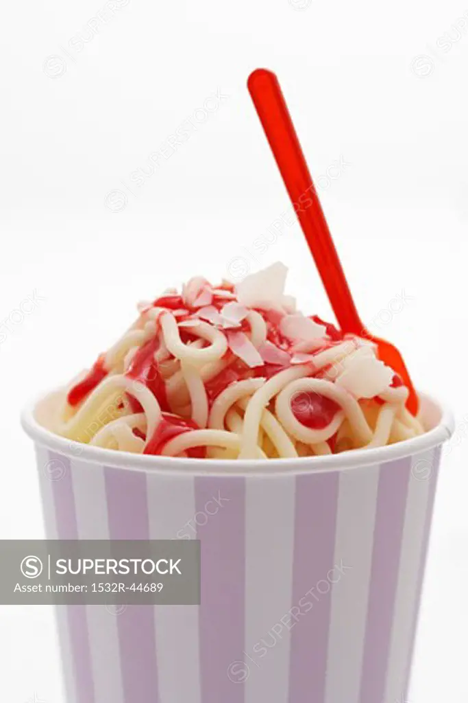 Ice cream spaghetti with strawberry sauce in tub
