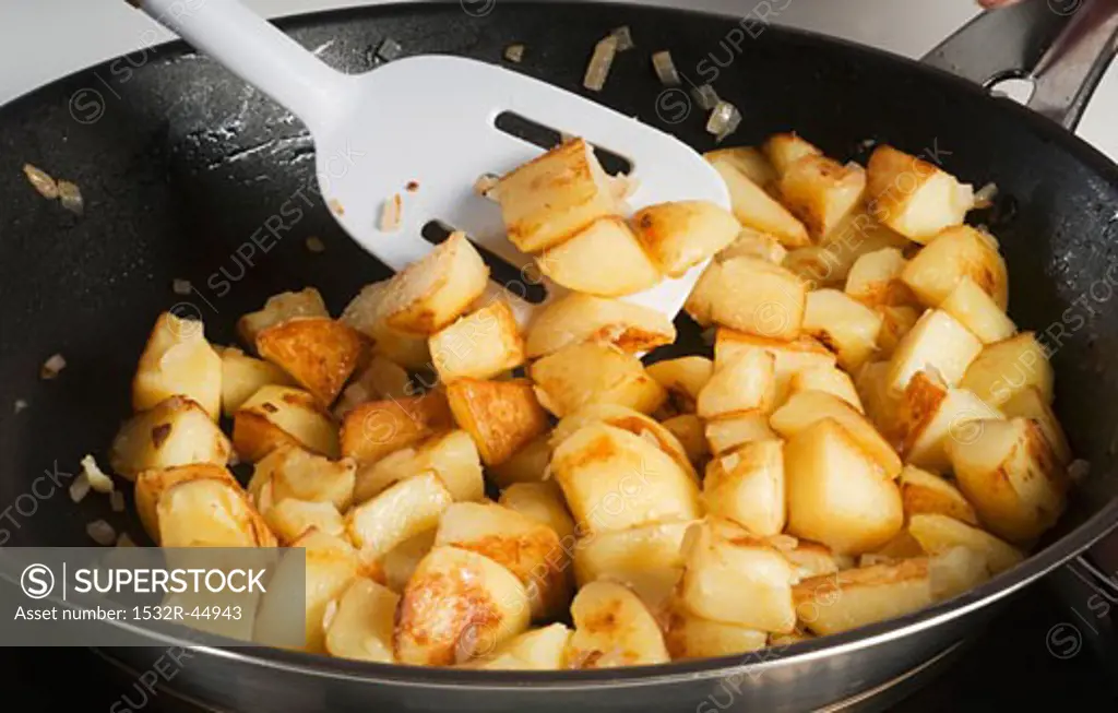 Fried potatoes with onions in a frying pan