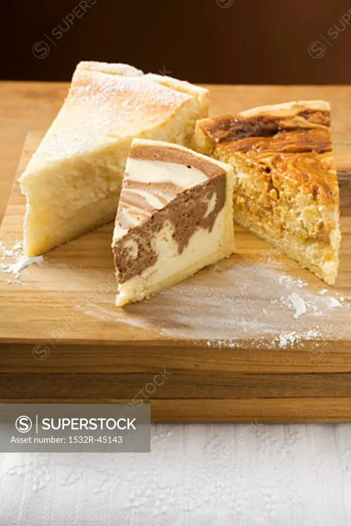 Pieces of three different cakes (cheesecakes, rice cake)