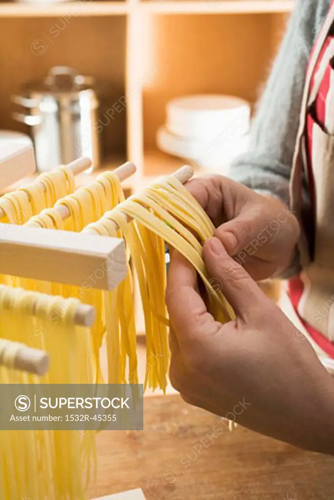 Hanging home-made ribbon pasta up to dry