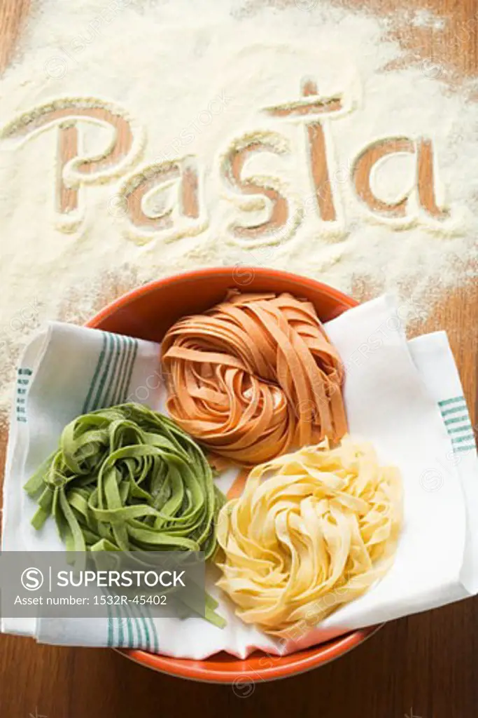 Home-made ribbon pasta and the word 'Pasta'