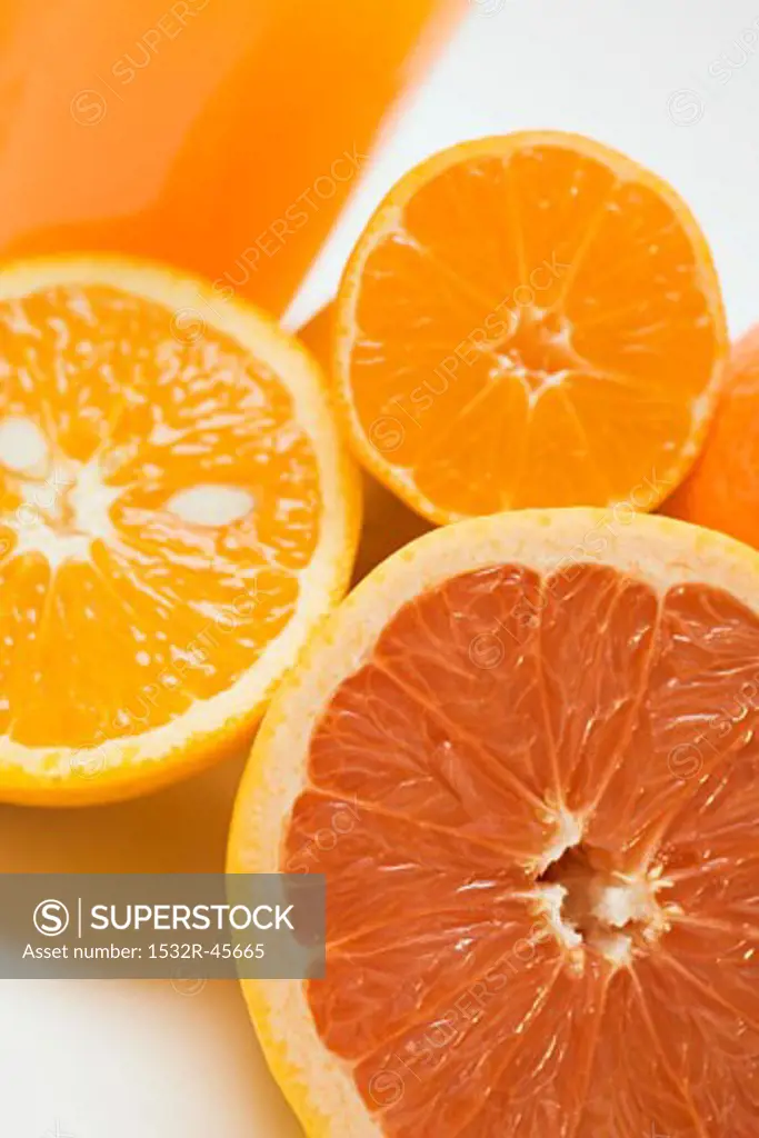 Glass of orange juice, grapefruit and oranges