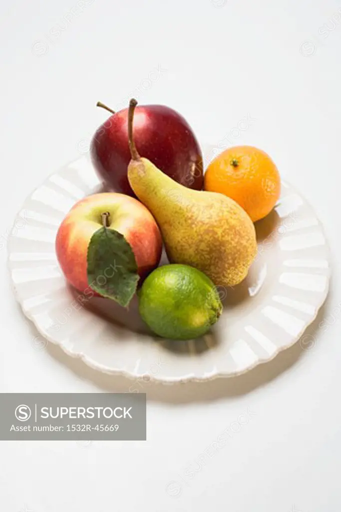 Core fruit and citrus fruit on white plate