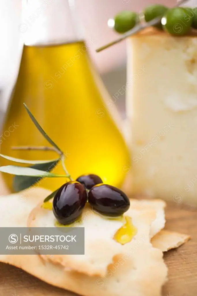 Black olives, crackers, olive oil and Parmesan
