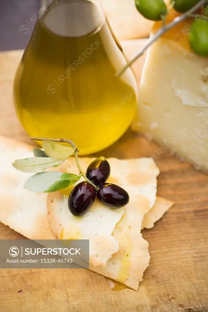 Olives, crackers, olive oil and Parmesan