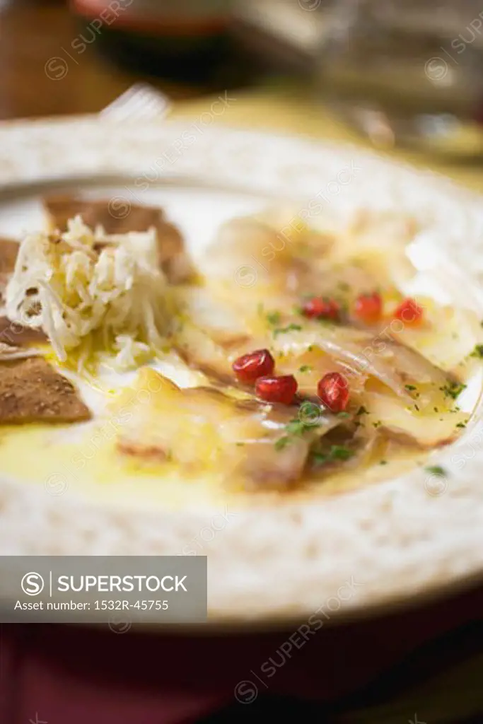 Fish carpaccio with pomegranate seeds