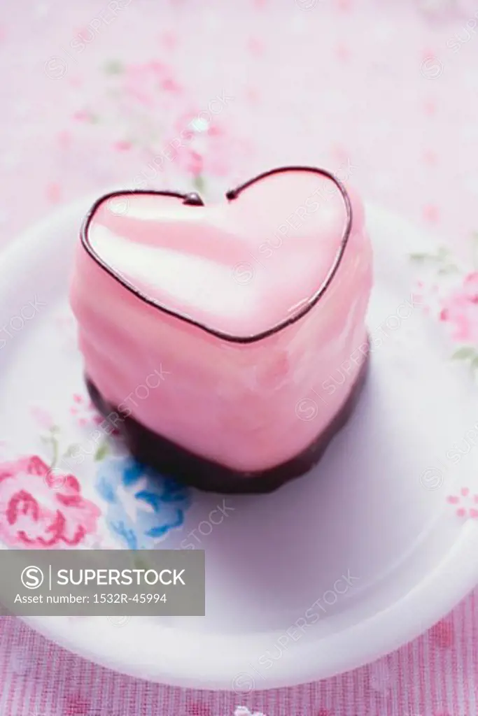 Pink heart-shaped petit four on plate