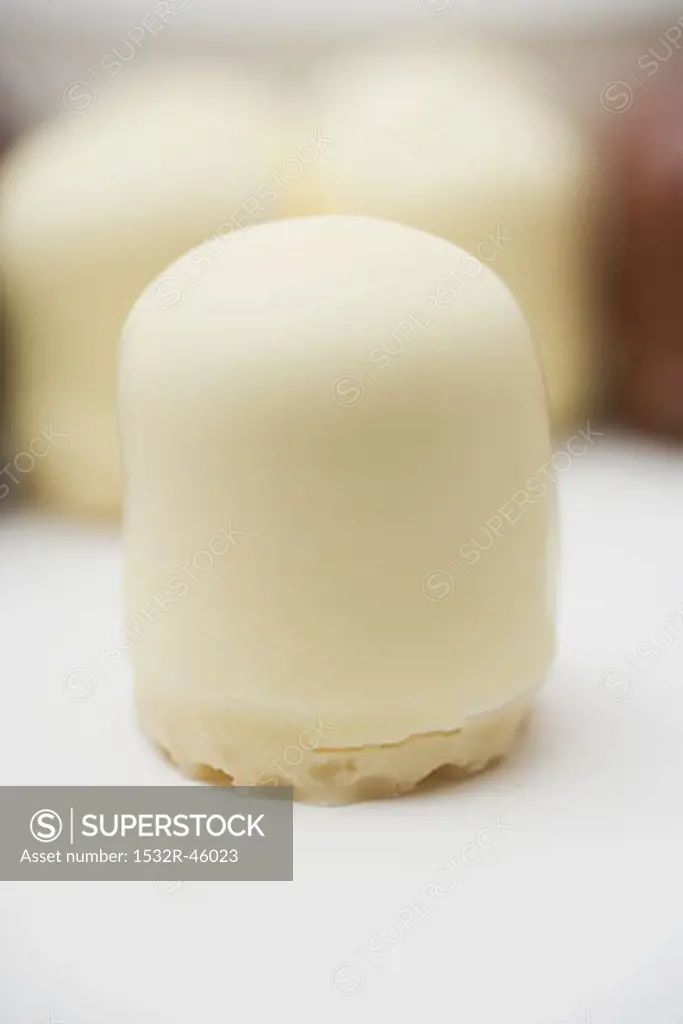 White chocolate-covered marshmallow wafer, several in background