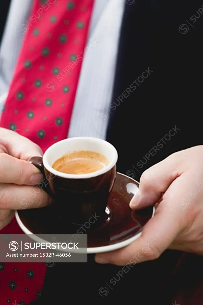 Man holding cup of espresso