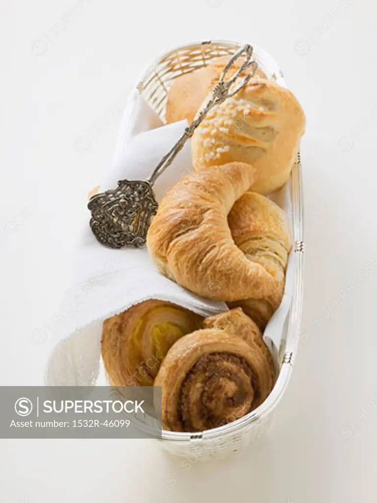 Croissant and sweet pastries in bread basket