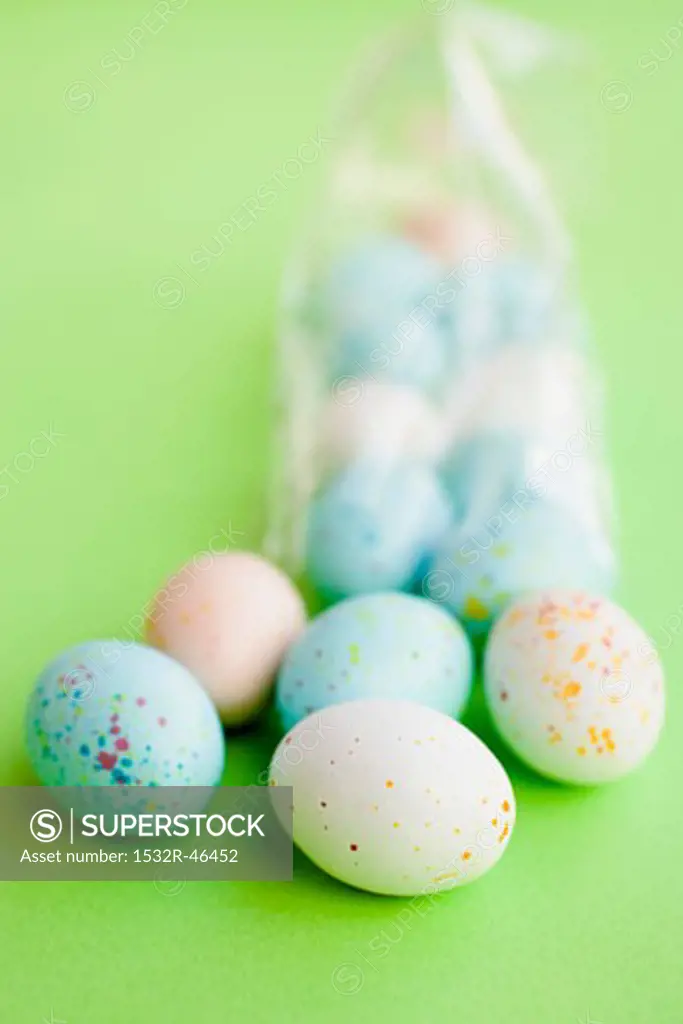 Pastel-coloured Easter eggs, some in cellophane bag