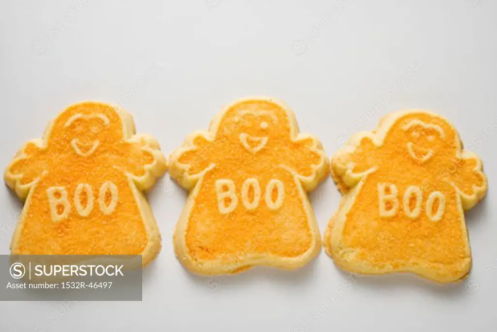 Three orange ghost biscuits for Halloween