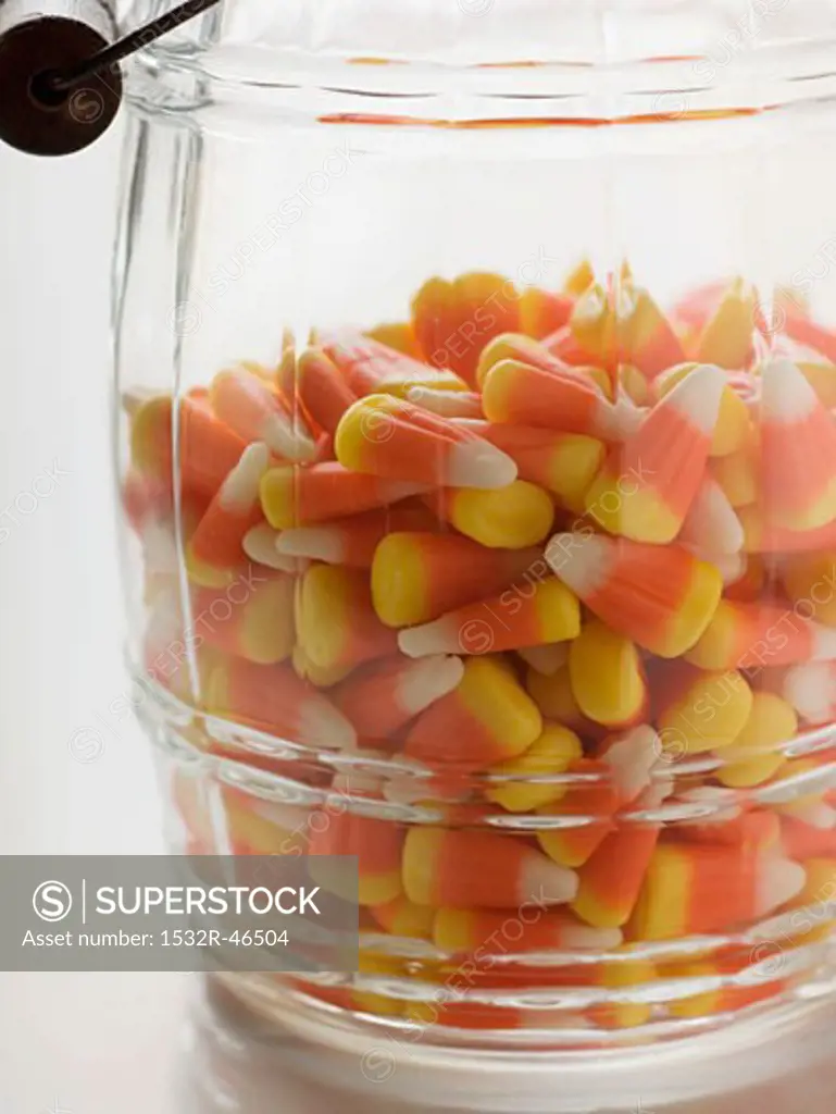 Candy corn (Halloween sweets, USA) in storage jar