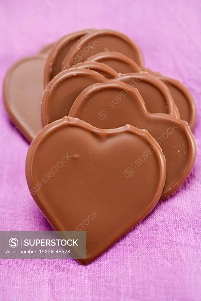 Chocolate hearts on purple background