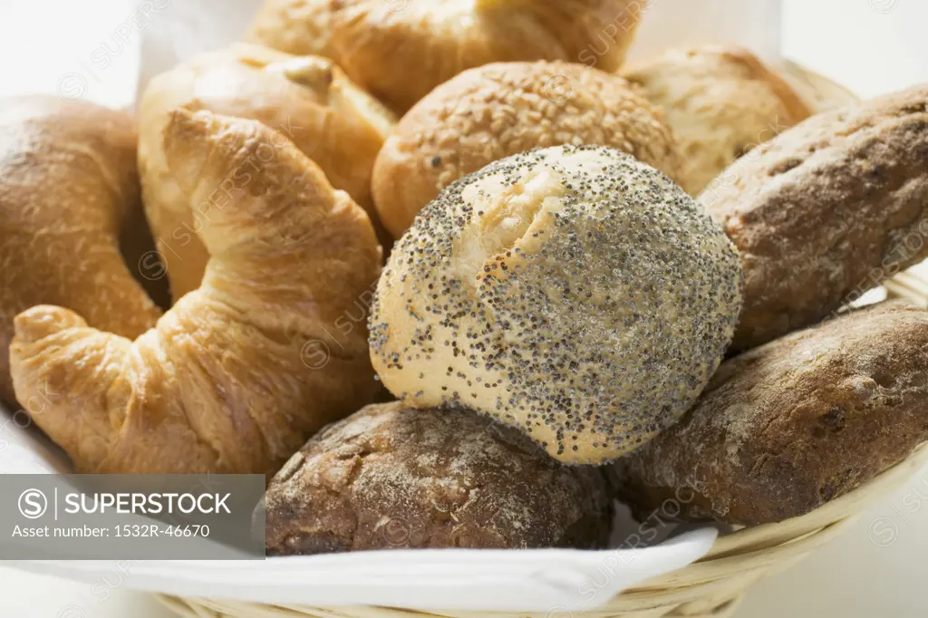 Bread rolls and croissants in bread basket