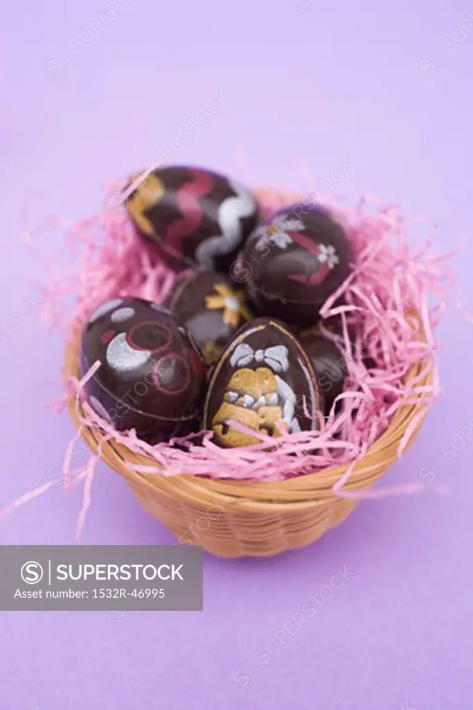 Painted chocolate eggs in Easter nest