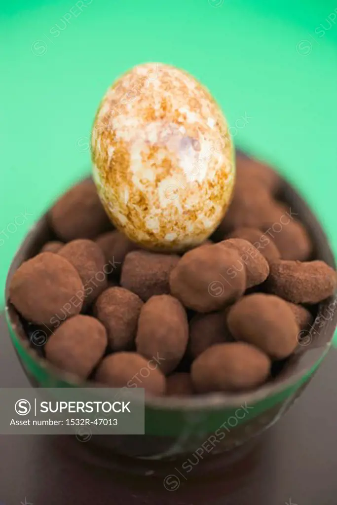 Half a chocolate egg filled with small truffles