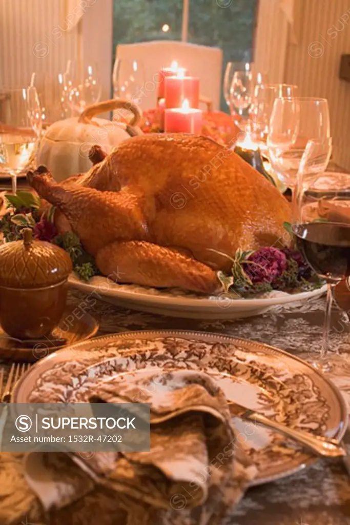 Stuffed turkey on table laid for Thanksgiving (USA)