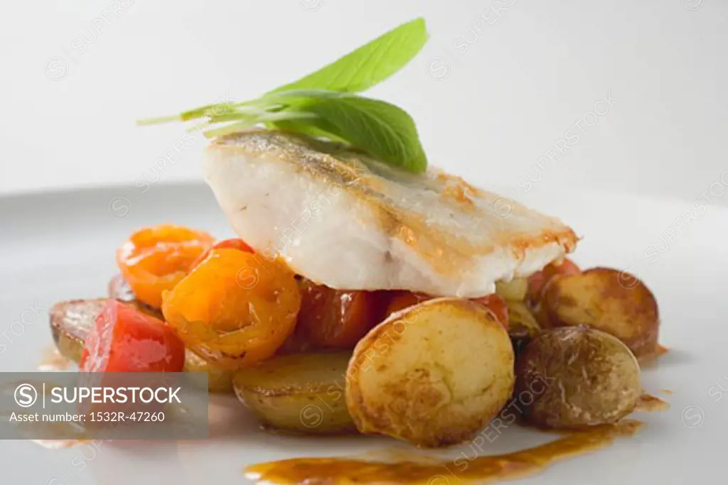 Fish fillet with fried potatoes and cherry tomatoes