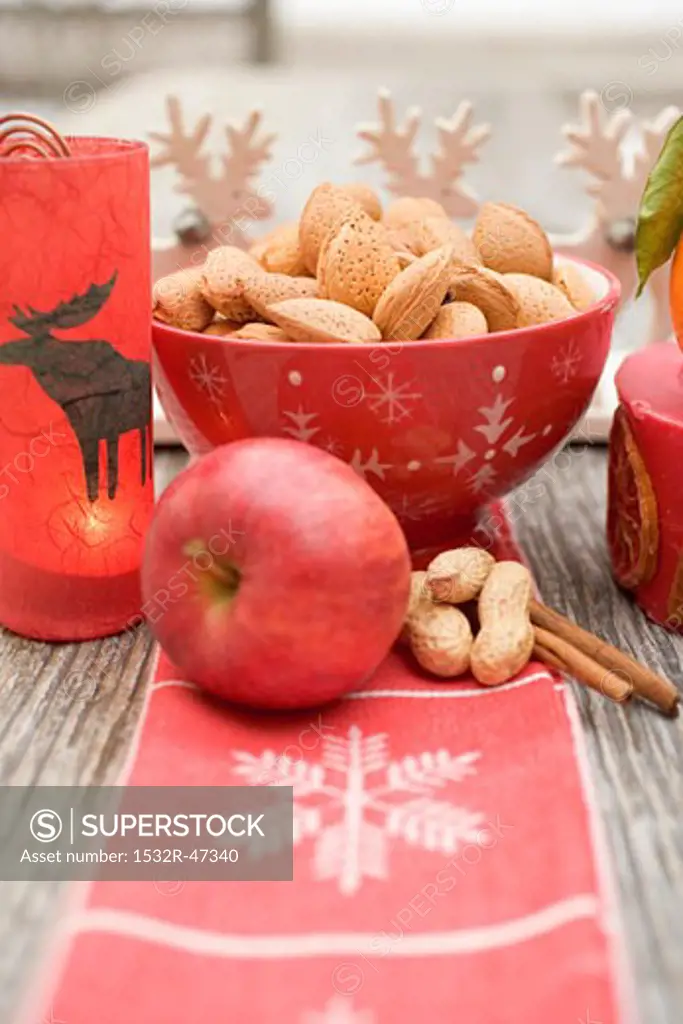 Christmas decoration: nuts, apple, cinnamon and candle