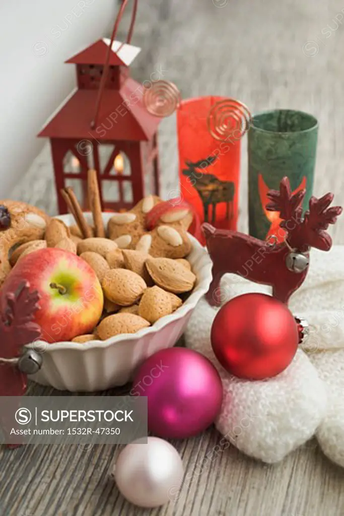 Christmas decoration with apple, nuts, lantern, mittens