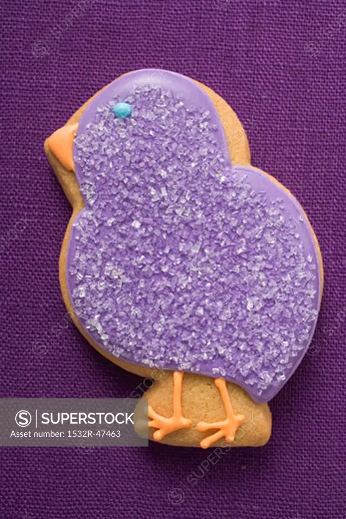 Easter biscuit (purple chick) on purple linen