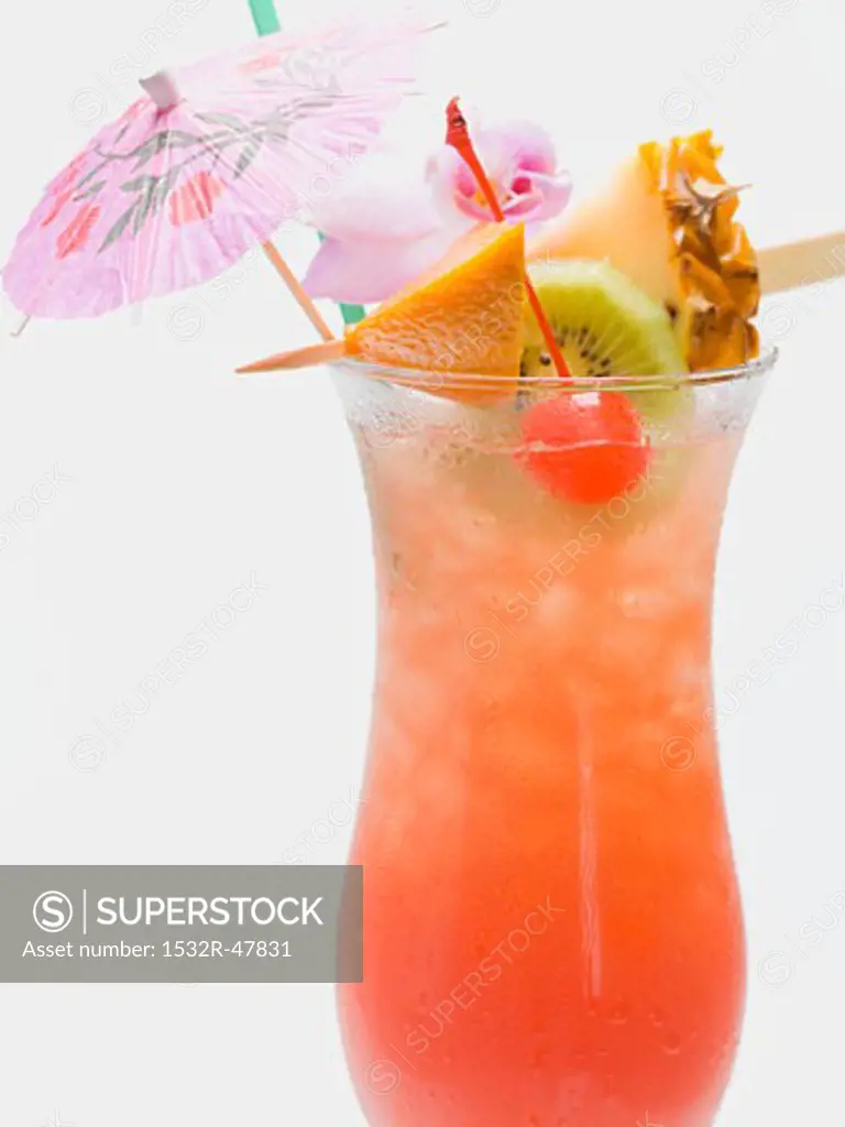 Cocktail with exotic fruit skewer and umbrella
