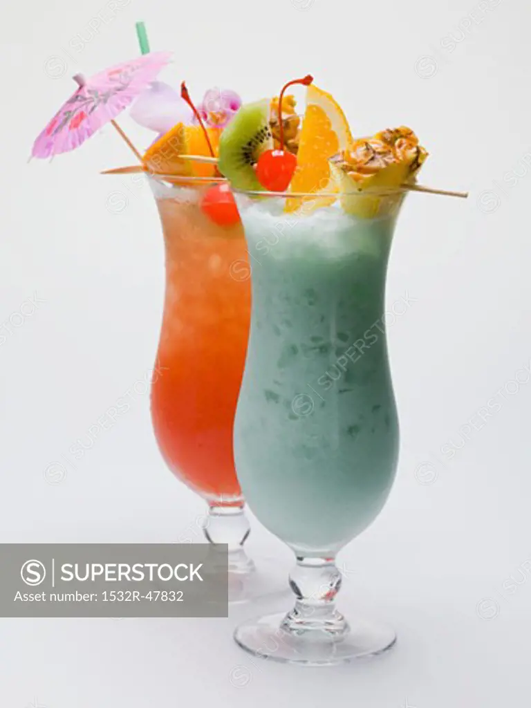 Two Caribbean long drinks with fruit skewers