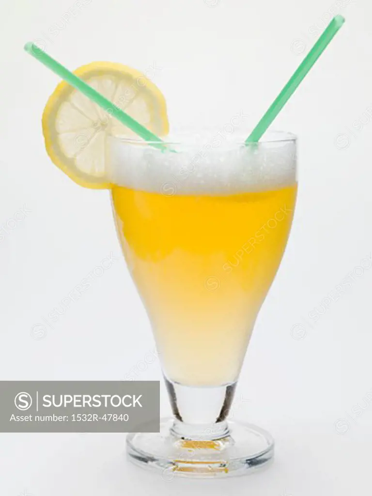 Glass of shandy with slice of lemon and straws (UK)