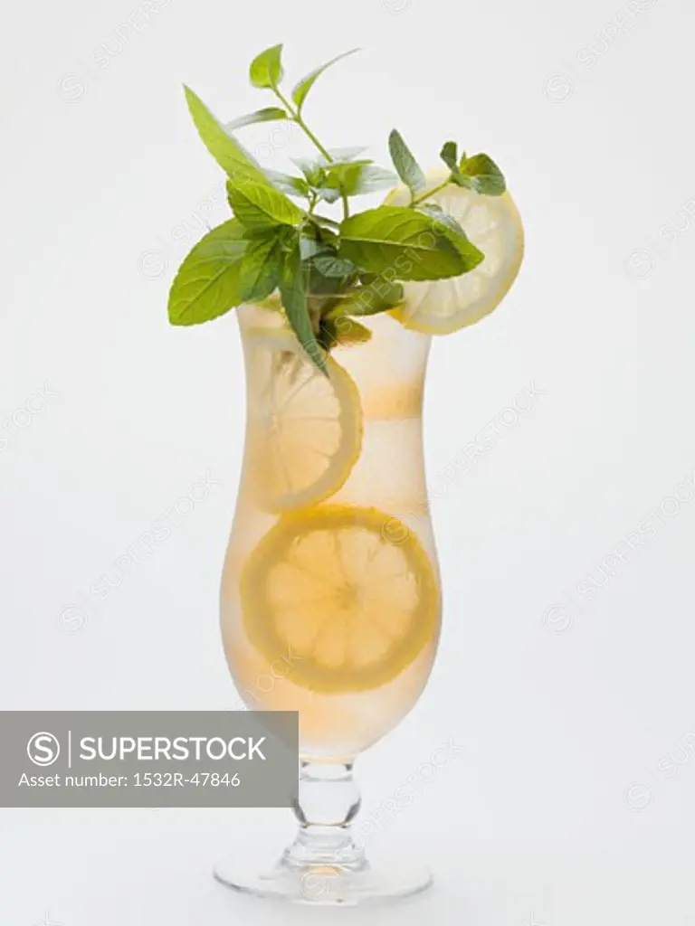 Glass of iced tea with lemon slices and fresh mint