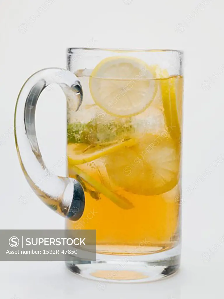 Iced tea with lemon slices in glass jug