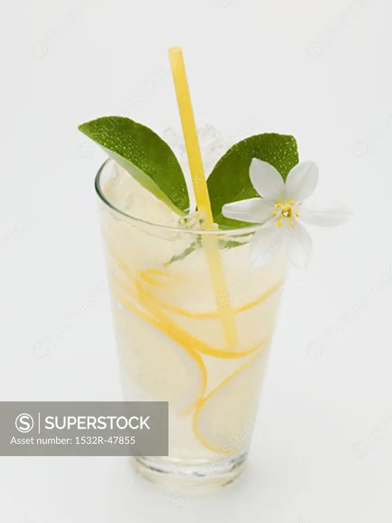 A glass of lemonade with lemon blossom and straw