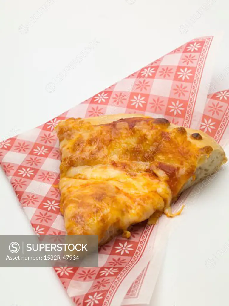 Slice of pizza Margherita (tomato & cheese pizza) on napkin