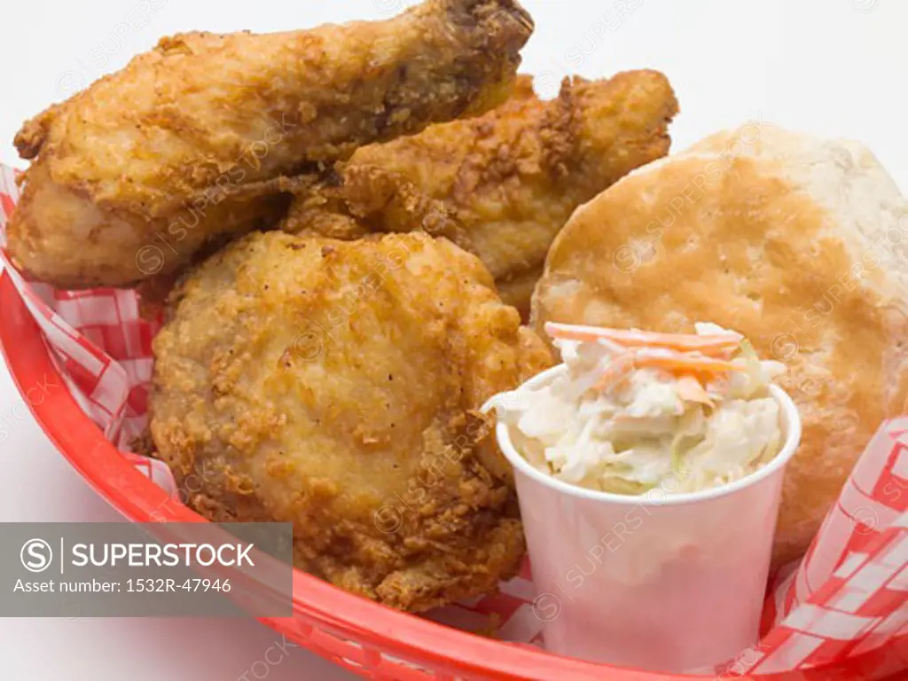 Fried chicken with coleslaw and scone in plastic basket