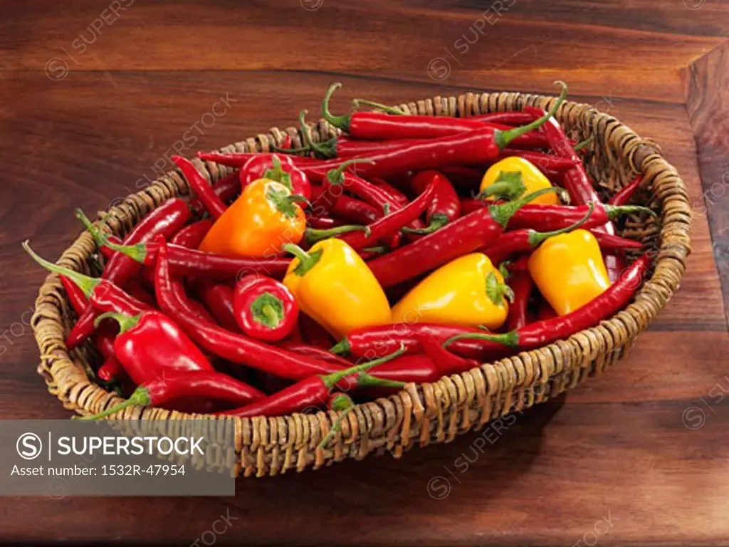 Fresh chillies and small peppers in basket