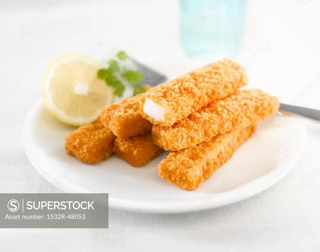 Fish fingers with lemon on plate