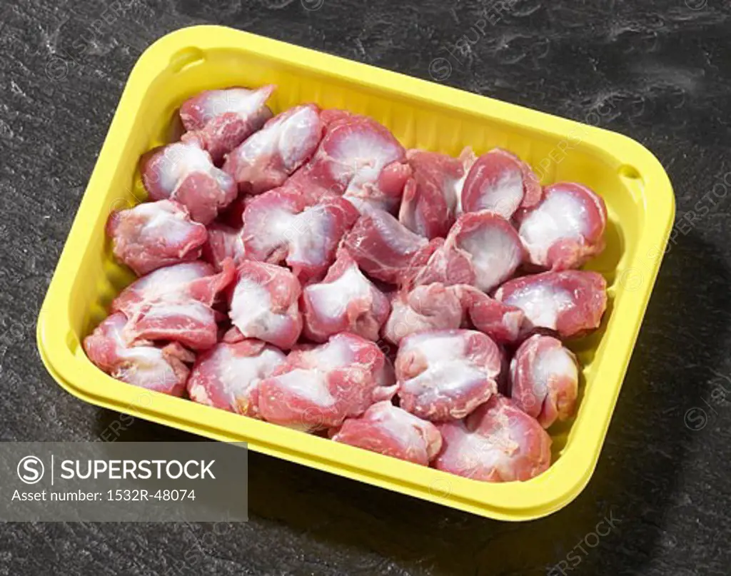Chicken stomachs in plastic container