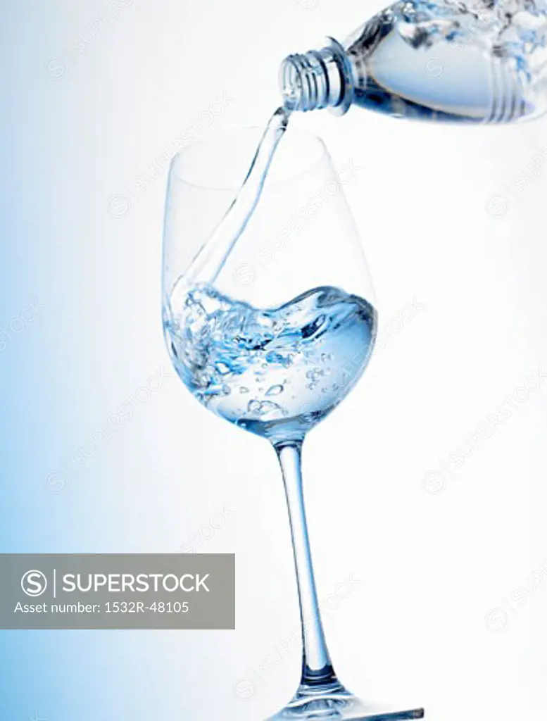 Pouring water into a glass