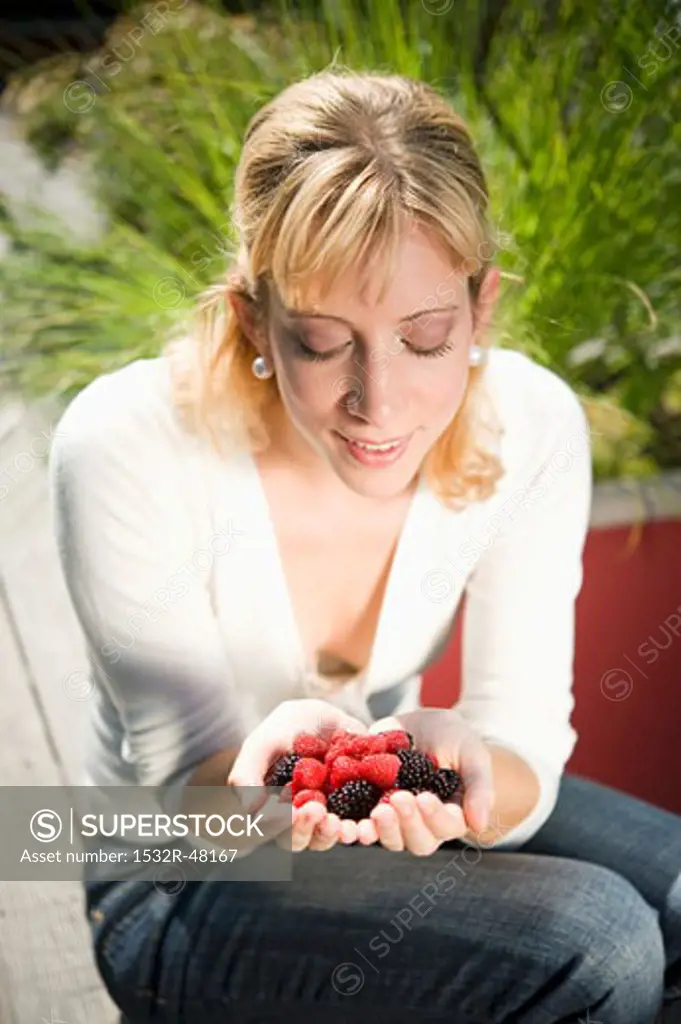 Woman holding fresh berries in her hands