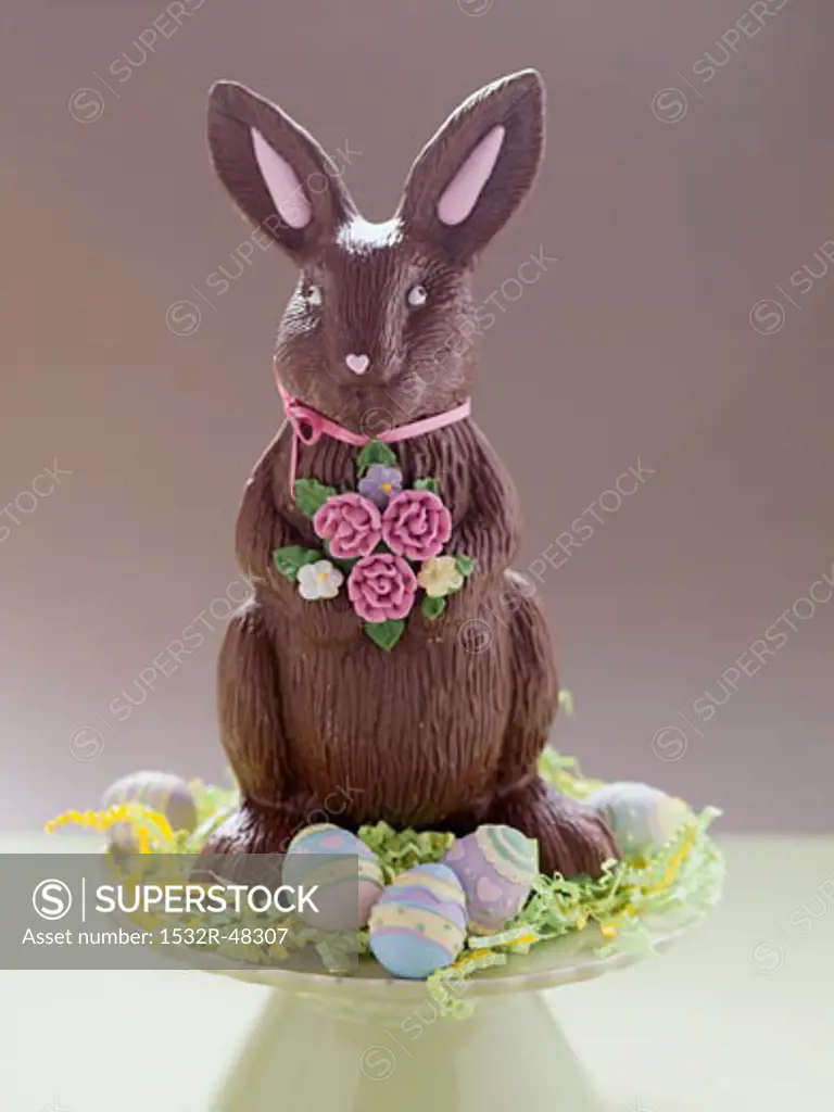 Chocolate Easter Bunny surrounded by Easter eggs