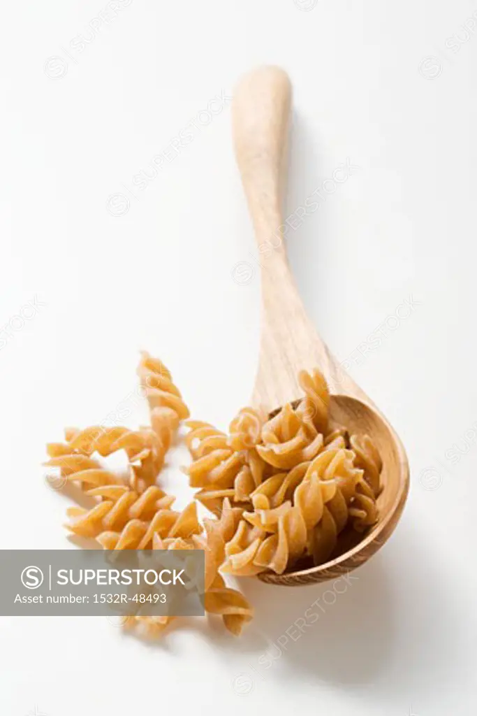 Wholemeal fusilli with wooden spoon